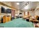Cozy finished basement featuring a lounge area, workspace, and an exercise area with a treadmill at 52 Cherub Ln, Sharpsburg, GA 30277