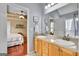 Bathroom with double vanity, wood cabinets, and a glimpse into an adjoining bedroom at 52 Cherub Ln, Sharpsburg, GA 30277