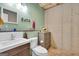 Bathroom featuring updated vanity and fixtures with a painted green wall at 52 Cherub Ln, Sharpsburg, GA 30277