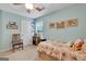 Bedroom featuring a window, ceiling fan, and comfortable decor at 52 Cherub Ln, Sharpsburg, GA 30277