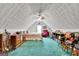 Bedroom in the loft features sloped ceilings, ceiling fan, queen bed and carpeting at 52 Cherub Ln, Sharpsburg, GA 30277