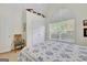 Bedroom with a large window, white vaulted ceiling, and a patterned bedspread at 52 Cherub Ln, Sharpsburg, GA 30277