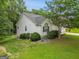 Well-kept home exterior with vinyl siding, manicured landscaping, and a peaceful, private setting at 52 Cherub Ln, Sharpsburg, GA 30277