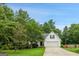 Charming single-Gathering home with a well-maintained lawn, mature trees, and attached two-car garage at 52 Cherub Ln, Sharpsburg, GA 30277