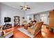 Well-lit living room with hardwood floors, high ceilings, and comfortable seating arrangements for relaxing at 52 Cherub Ln, Sharpsburg, GA 30277