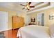 Main bedroom offers a tray ceiling, en-suite access and gleaming hardwood floors at 52 Cherub Ln, Sharpsburg, GA 30277