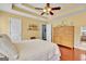 Spacious main bedroom offers a tray ceiling, en-suite access and beautiful flooring at 52 Cherub Ln, Sharpsburg, GA 30277