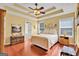 Relaxing bedroom boasts tray ceilings, warm hardwood floors and plenty of natural light at 52 Cherub Ln, Sharpsburg, GA 30277