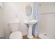 Bathroom featuring a pedestal sink, toilet, shower, and blue and white shower curtain at 3686 Calmer Cir, East Point, GA 30344