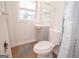 Compact bathroom features a vanity with storage, toilet, and shower with a decorative curtain at 3686 Calmer Cir, East Point, GA 30344