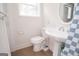 Bathroom featuring a pedestal sink, toilet, and a window for natural light at 3686 Calmer Cir, East Point, GA 30344