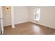 Cozy bedroom with hardwood floors, natural light from a window, and white walls at 3686 Calmer Cir, East Point, GA 30344