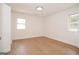Light-filled bedroom with hardwood flooring, modern lighting, and two windows for natural light at 3686 Calmer Cir, East Point, GA 30344