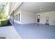 The open carport features grey flooring and a door to inside at 3686 Calmer Cir, East Point, GA 30344