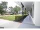 Long covered porch features gray flooring, ironwork, and manicured landscaping at 3686 Calmer Cir, East Point, GA 30344