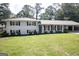 Charming white brick home features a well-manicured lawn and a covered carport at 3686 Calmer Cir, East Point, GA 30344