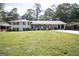 Charming white brick home with well-manicured lawn and covered carport at 3686 Calmer Cir, East Point, GA 30344
