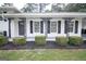 Inviting front porch with ironwork, black shutters, and manicured shrubs at 3686 Calmer Cir, East Point, GA 30344