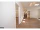 Hallway featuring hardwood floors, white walls, and a view to the second floor at 3686 Calmer Cir, East Point, GA 30344