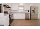 Eat-in kitchen with stainless appliances, granite counters, and modern white cabinetry at 3686 Calmer Cir, East Point, GA 30344