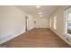 Bright living room features hardwood floors, white walls, and natural light from large windows at 3686 Calmer Cir, East Point, GA 30344