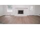 Living room featuring hardwood floors, a white brick fireplace, and natural light from the window at 3686 Calmer Cir, East Point, GA 30344
