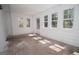 Bright sunroom with white walls, many windows, and a door leading outside at 3686 Calmer Cir, East Point, GA 30344
