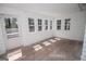 Bright sunroom with white walls, many windows, and a door leading outside at 3686 Calmer Cir, East Point, GA 30344