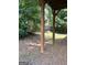 Backyard beneath a wooden deck featuring pine straw groundcover and lush surrounding foliage at 375 Sapphire Bnd, Riverdale, GA 30296