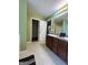 Bathroom with dual vanity, tile floors and view of the walk-in closet at 375 Sapphire Bnd, Riverdale, GA 30296
