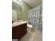 Bathroom featuring a vanity with a sink and a toilet with a fern-patterned shower curtain at 375 Sapphire Bnd, Riverdale, GA 30296