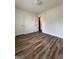 Bedroom featuring hardwood floors, white trim, and a view into the hallway at 375 Sapphire Bnd, Riverdale, GA 30296