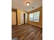Bedroom with wood-look floors, natural light from window, and closet for ample storage at 375 Sapphire Bnd, Riverdale, GA 30296