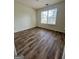 Bedroom featuring hardwood floors, a window providing natural light, and neutral colored walls at 375 Sapphire Bnd, Riverdale, GA 30296