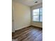Bedroom featuring hardwood floors, a window providing natural light, and white walls at 375 Sapphire Bnd, Riverdale, GA 30296