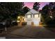 Two-story home with vinyl siding, a driveway, a two-car garage, and a charming entrance with steps at 375 Sapphire Bnd, Riverdale, GA 30296
