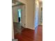 Hallway with hardwood floors leading to rooms with white doors and contrasting floor colors at 375 Sapphire Bnd, Riverdale, GA 30296