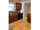 Functional kitchen with a window, tile flooring, and wooden cabinets at 375 Sapphire Bnd, Riverdale, GA 30296