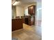Kitchen with tile flooring, dark wood cabinetry, and black appliances at 375 Sapphire Bnd, Riverdale, GA 30296
