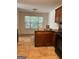 Kitchen showcasing tile floors, wooden cabinets and an island with an adjacent dining area at 375 Sapphire Bnd, Riverdale, GA 30296