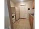 Compact kitchenette with white appliances and wood cabinets at 375 Sapphire Bnd, Riverdale, GA 30296