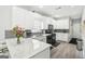 Bright kitchen with white cabinets, granite countertops and stainless steel appliances at 1010 Capella Creek Way, Grayson, GA 30017