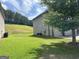Spacious backyard with a lush lawn and mature trees, providing shade and privacy for outdoor enjoyment at 8109 Nolan Trl, Snellville, GA 30039