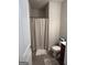 Small full bathroom including a toilet, shower with a curtain and tile flooring at 8109 Nolan Trl, Snellville, GA 30039