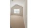 Simple bedroom with vaulted ceilings, neutral carpet, and plenty of natural light from the window at 8109 Nolan Trl, Snellville, GA 30039