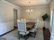 Elegant dining room with a chandelier, wainscoting, and a large wooden table with seating for six at 8109 Nolan Trl, Snellville, GA 30039