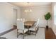 Bright dining room with elegant chandelier, wainscoting, and large table for gatherings at 8109 Nolan Trl, Snellville, GA 30039