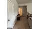 Hallway view reveals neutral walls, carpet, and sightline into the tiled bathroom with shower curtain at 8109 Nolan Trl, Snellville, GA 30039