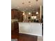Open kitchen with wooden cabinets, granite countertops, and pendant lighting over the bar at 8109 Nolan Trl, Snellville, GA 30039