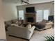 Cozy living room with a stone fireplace, neutral furniture and French doors to the outside at 8109 Nolan Trl, Snellville, GA 30039